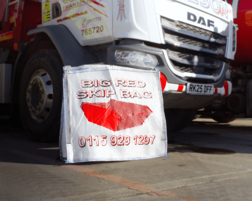 Skip bag in front of skip hire truck ready for collection and waste removal service
